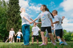 Children holding hands in a UK school setting, representing safeguarding and child protection